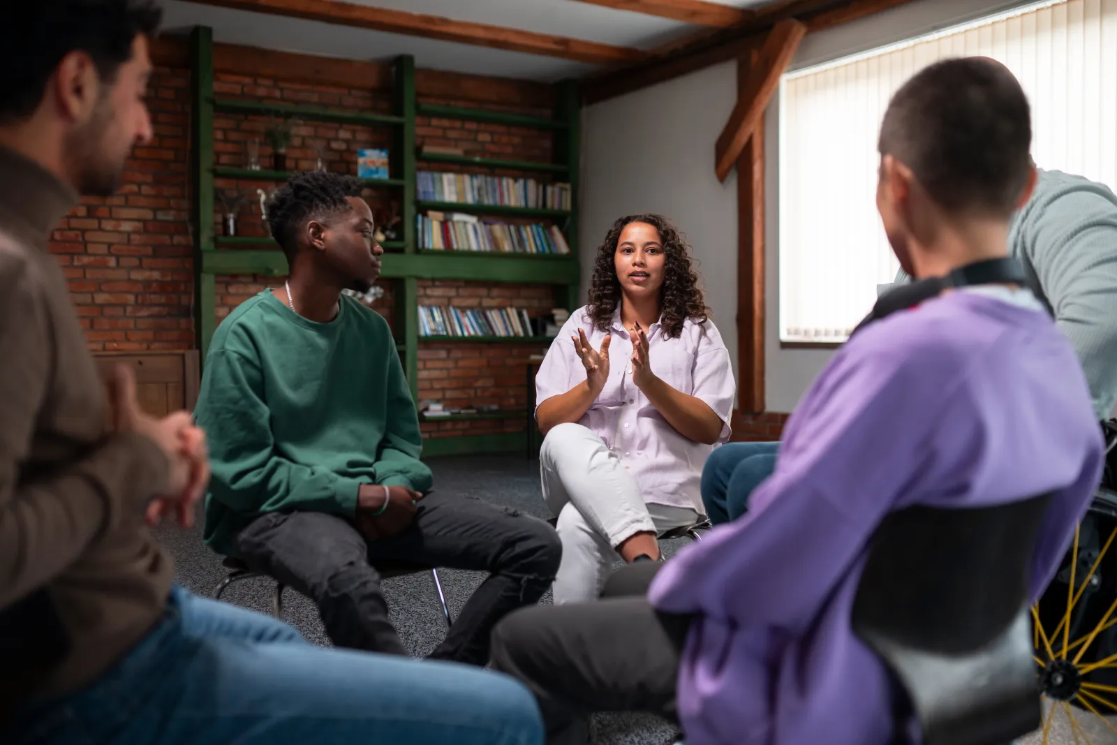 People meeting together in a supportive wellness group
